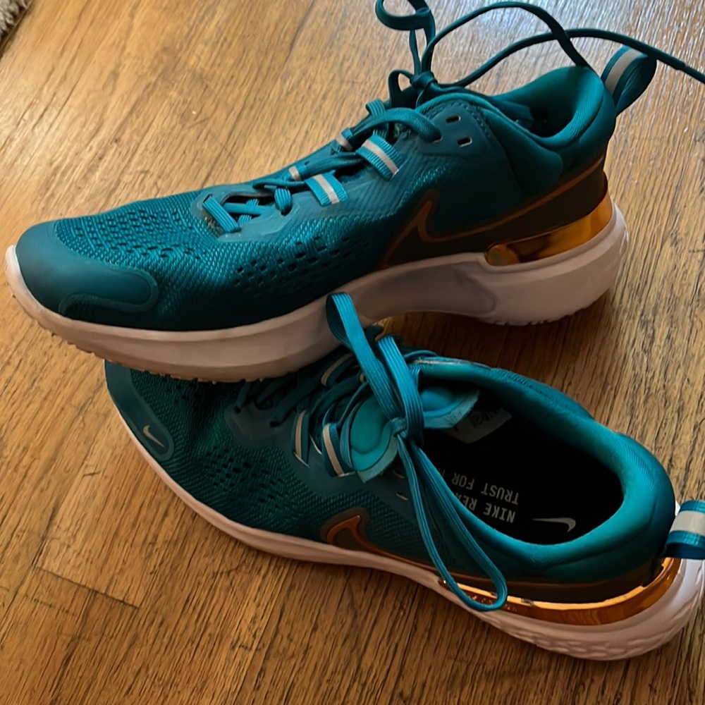 Custom rose gold and teal Nike storm threat training shoes.